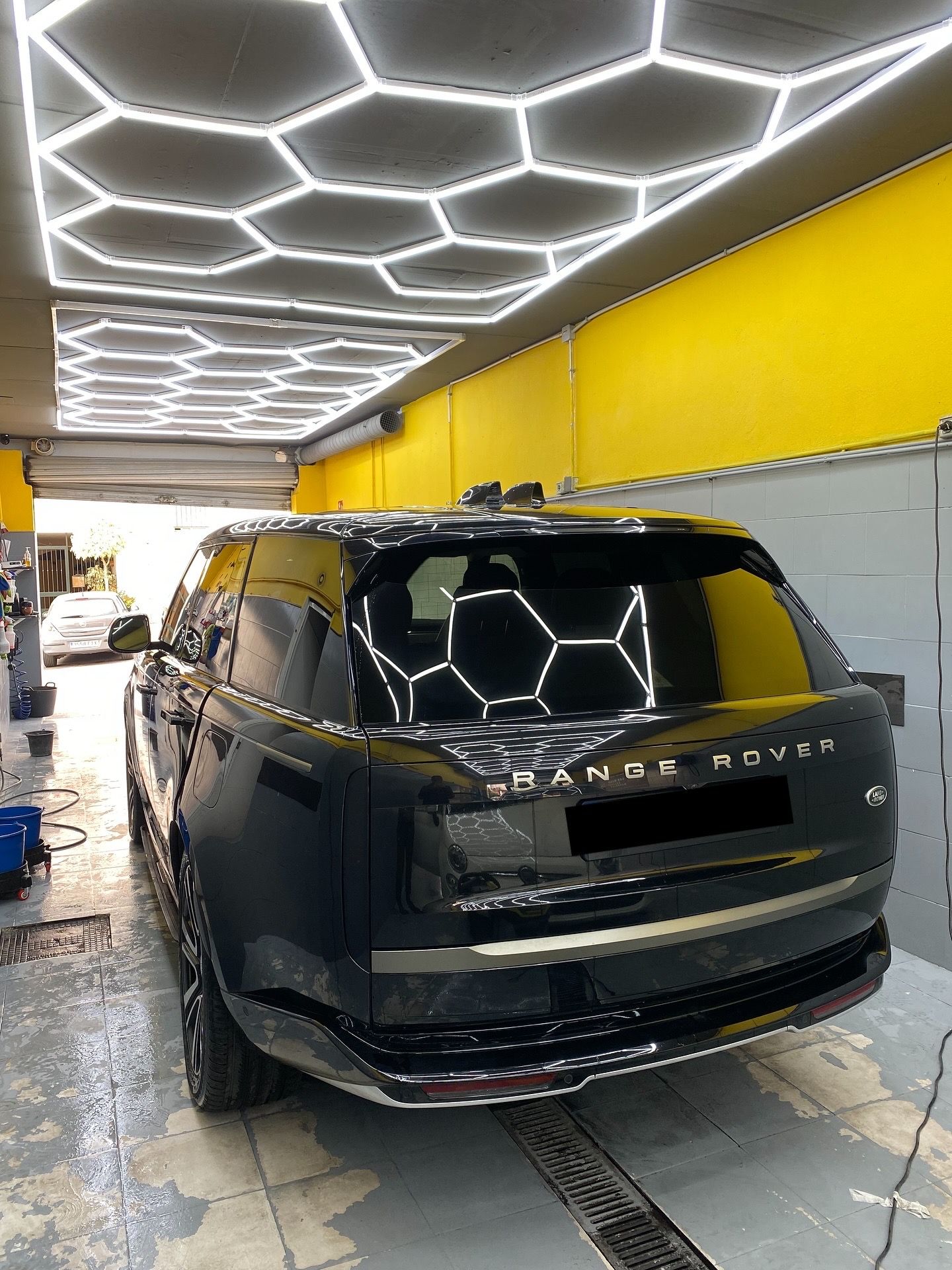 Range Rover at our car wash under the hexagonal LED ceiling — upholstery cleaning in San Pedro de Alcántara